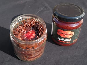 A chocolate cake made in a jar with buttercream icing and Matthew's Preserved Strawberry Jam